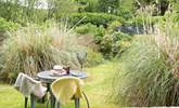 Enjoy al fresco dining in this sunny spot. - Thumbnail Image