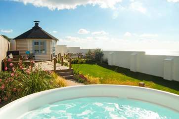 Looking from the hot tub towards the decked sitting-area and the barbecue hut.