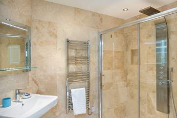 The en-suite shower room for Bedroom 2 with a column drench head shower