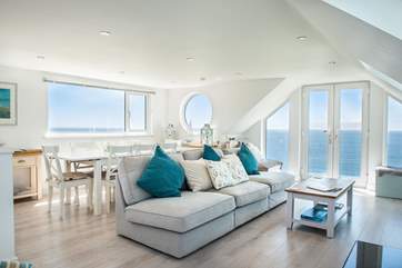 The open plan living room encompasses all of the first floor making the most of those sea views