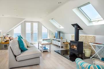 The living room is flooded with light thanks to the patio doors and velux skylights