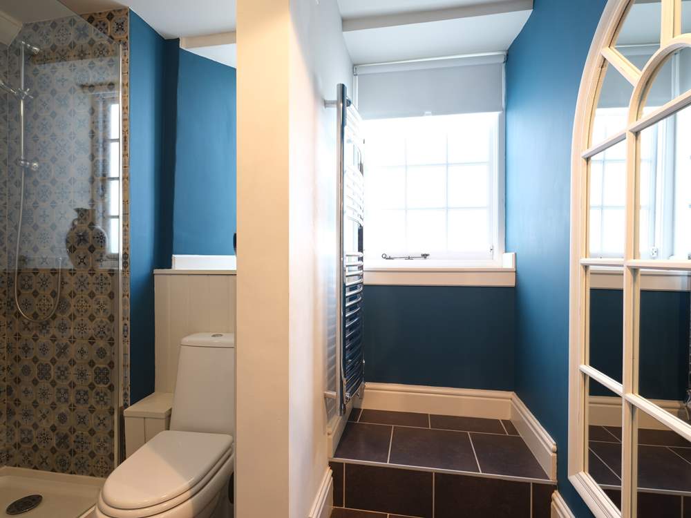 The shower-room is adjacent to the bedroom on the ground floor.