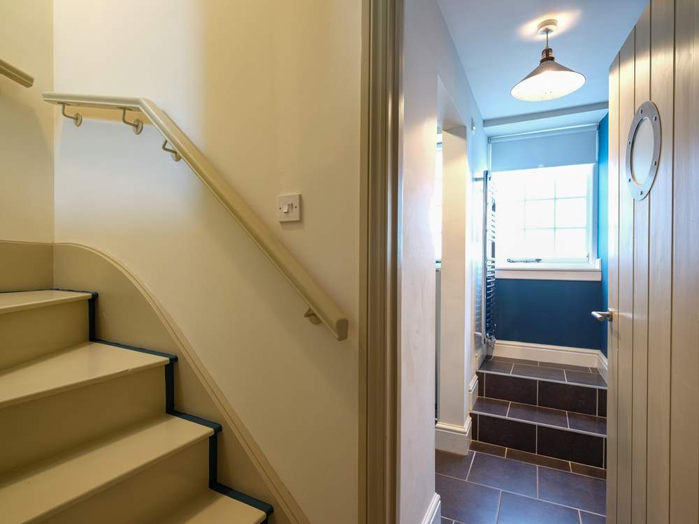 Stairs lead up to the living-room.