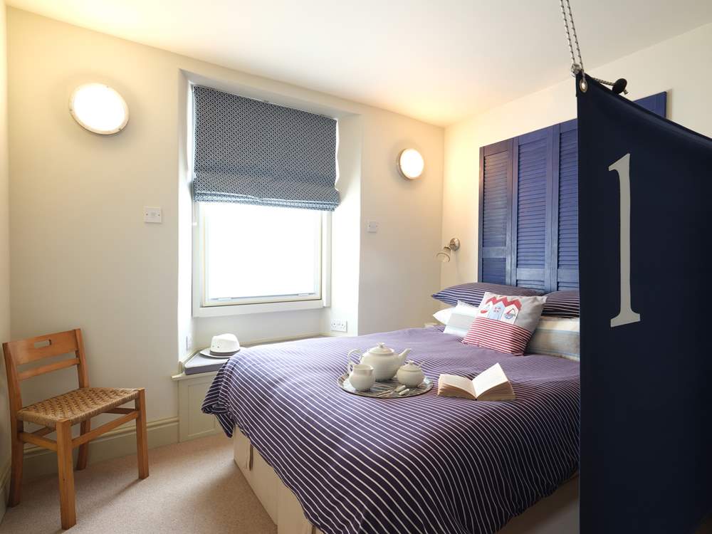 A canvas sail screens the bed.