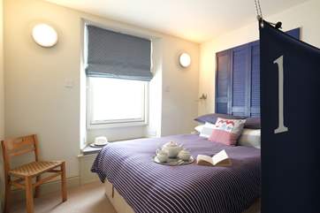 A canvas sail screens the bed.