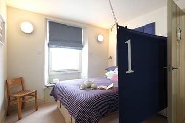 A canvas sail screens the bed.