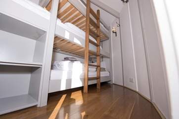 The triple bunk bedroom is in the smaller yurt.
