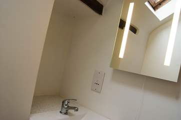 An illuminated mirror and shaver point in the shower-room.