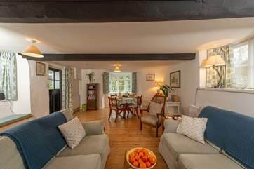 There is plenty of light in this lovely room. The bay window looks out towards the little bridge over the river ( there are privacy net curtains for those who wish )