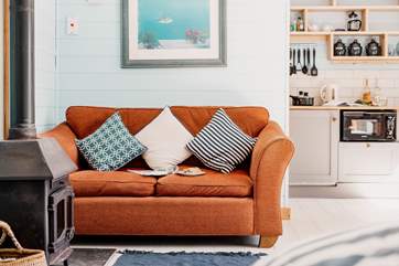 Light the wood burner and sink into the cosy sofa.
