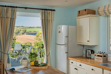 French doors open from the kitchen straight onto the decking with views of the hills beyond.