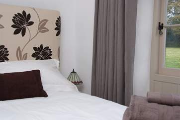 The bedroom looks out over the garden.