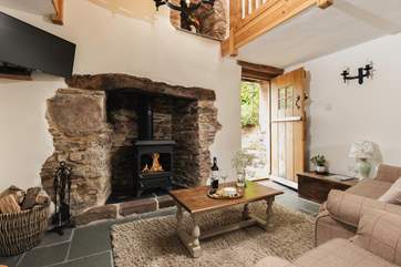 You step straight into this lovely living-area with the kitchen to the left and the back door to the garden on the right.