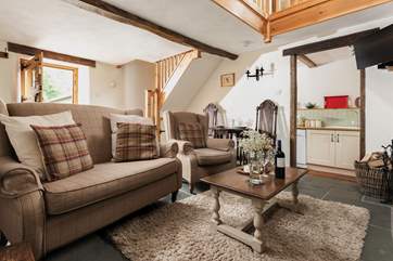 Looking back towards the front door, with the stairs leading up to the mezzanine level with the bedroom and shower-room.
