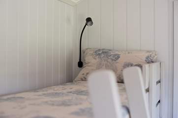 The bunk beds even have reading lamps for your convenience.