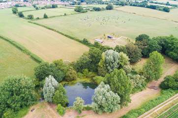 The lower meadow is where you can see the lakes and trees, and the whole area around it is for guests' sole use. The glamp-site can be seen above with Ottery St Mary in the distance.
