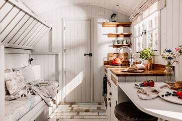 The top bunk-bed folds up, creating extra living space during the day.