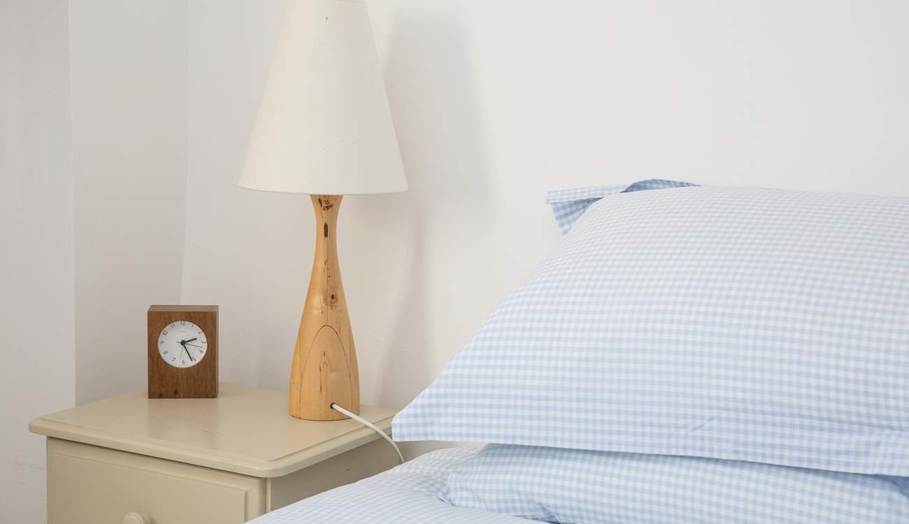 The pretty bedroom looks out onto the garden.