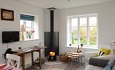 The kitchen/dining/sitting-room is the perfect place to relax after a day of exploring, with its cosy wood-burner. - Thumbnail Image