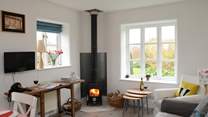 The kitchen/dining/sitting-room is the perfect place to relax after a day of exploring, with its cosy wood-burner.