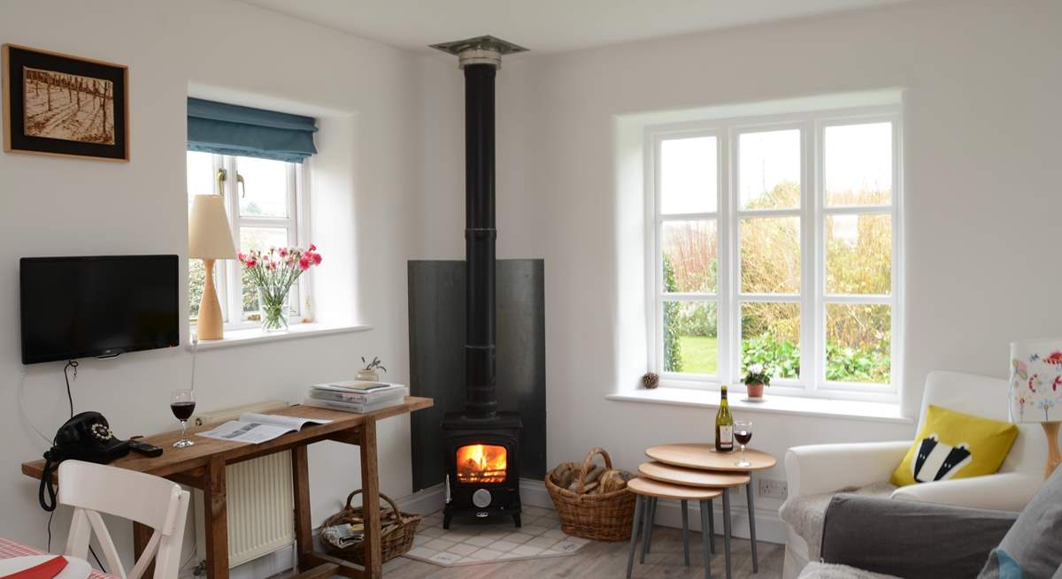 The kitchen/dining/sitting-room is the perfect place to relax after a day of exploring, with its cosy wood-burner.