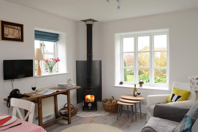The kitchen/dining/sitting-room is the perfect place to relax after a day of exploring, with its cosy wood-burner.