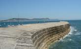 The iconic Cobb at Lyme Regis with Golden Cap in the background. - Thumbnail Image