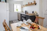 The compact kitchen is at one end of the open plan space.