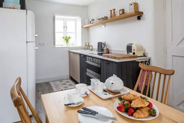 The compact kitchen is at one end of the open plan space.