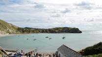 Lulworth Cove gets very busy during the summer months but take a walk along the Jurassic Coast to Durdle Door, an iconic landmark.