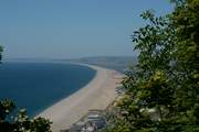 Chesil beach, taken from the Isle of Portland looking back along the Jurassic Coast towards Lyme Regis in the far distance.