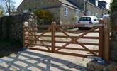 These electric gates at the entrance to the farm  are activated by driving onto a magnetic circuit under the concrete which reacts upon a car driving onto it. The gates will close automatically after. - Thumbnail Image