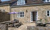 The French doors from the sitting/dining-room lead out onto the sheltered patio. - Thumbnail Image