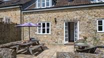 The French doors from the sitting/dining-room lead out onto the sheltered patio.