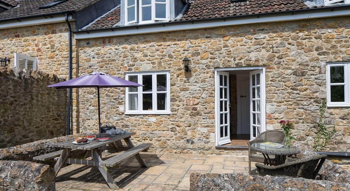 The French doors from the sitting/dining-room lead out onto the sheltered patio.