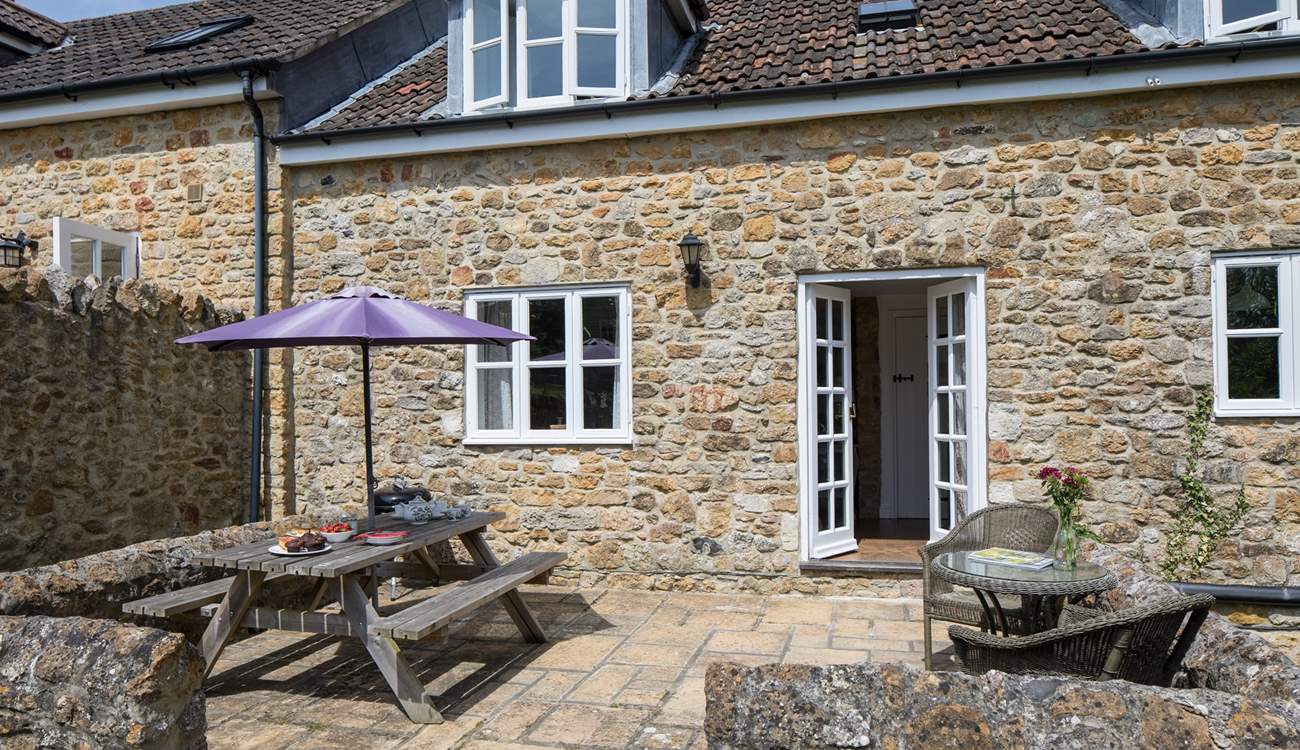 The French doors from the sitting/dining-room lead out onto the sheltered patio.