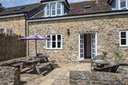 The French doors from the sitting/dining-room lead out onto the sheltered patio.
