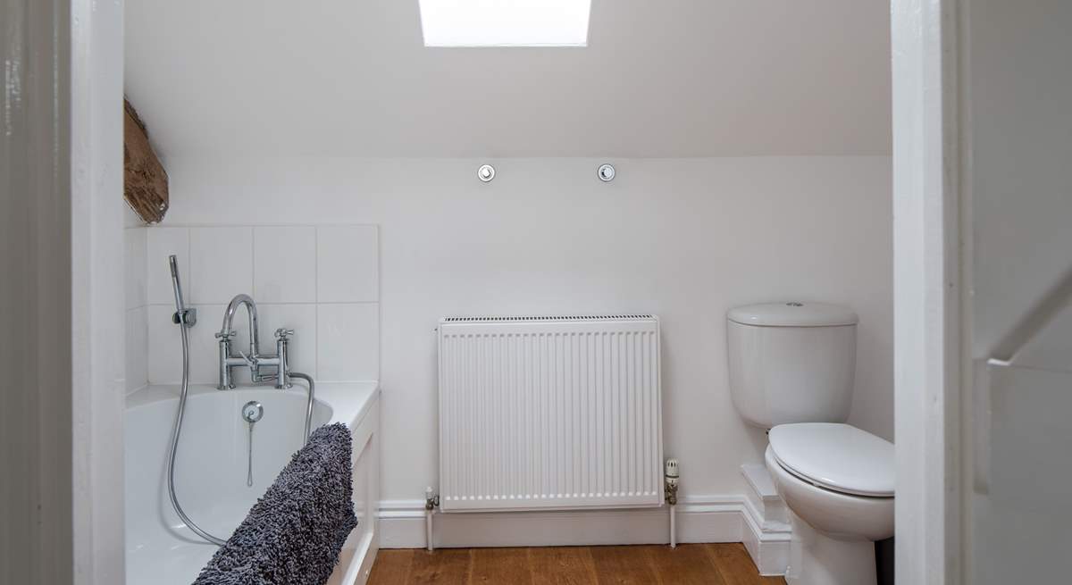 The spacious en suite bathroom has a hand held shower.