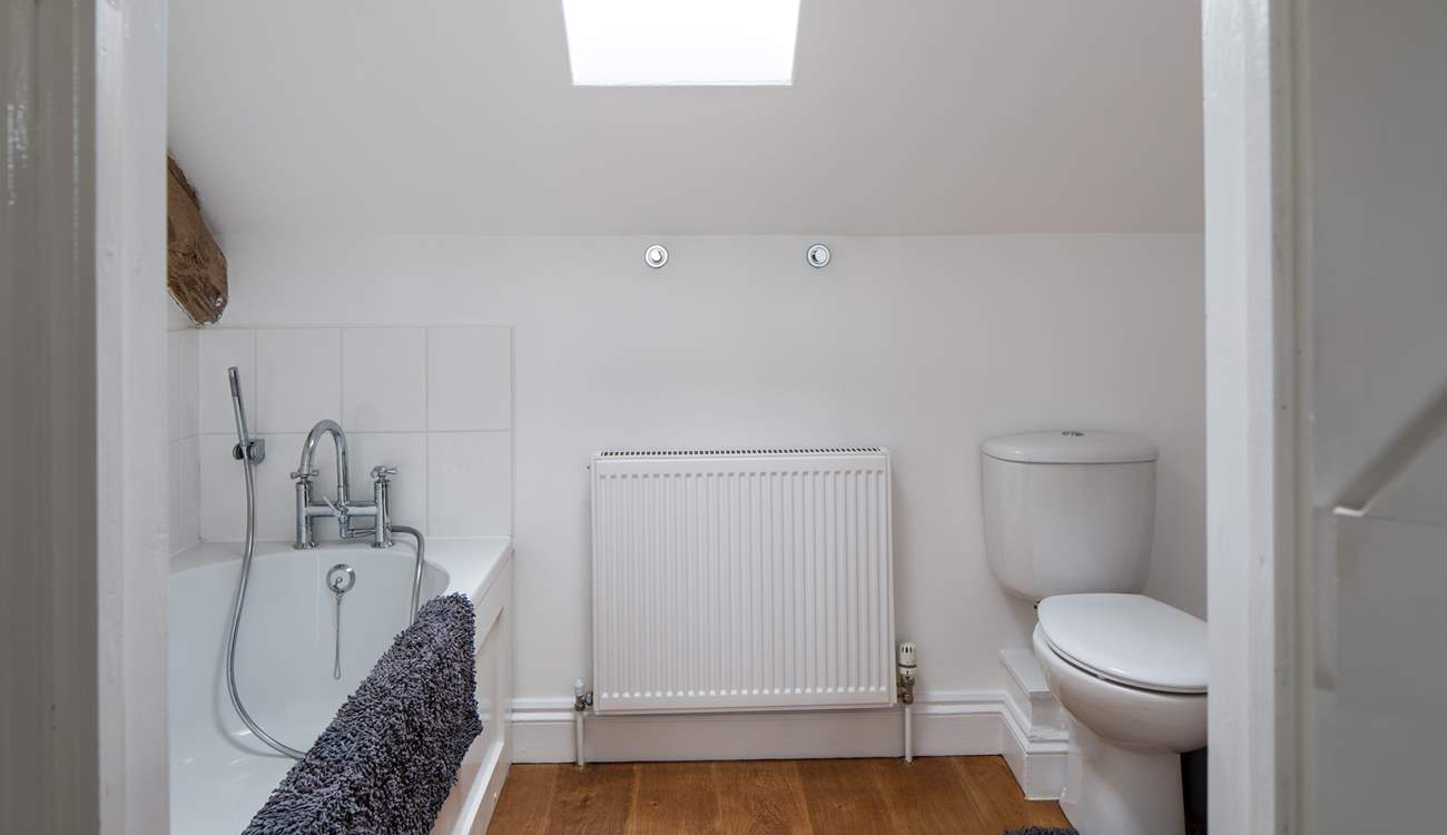 The spacious en suite bathroom has a hand held shower.