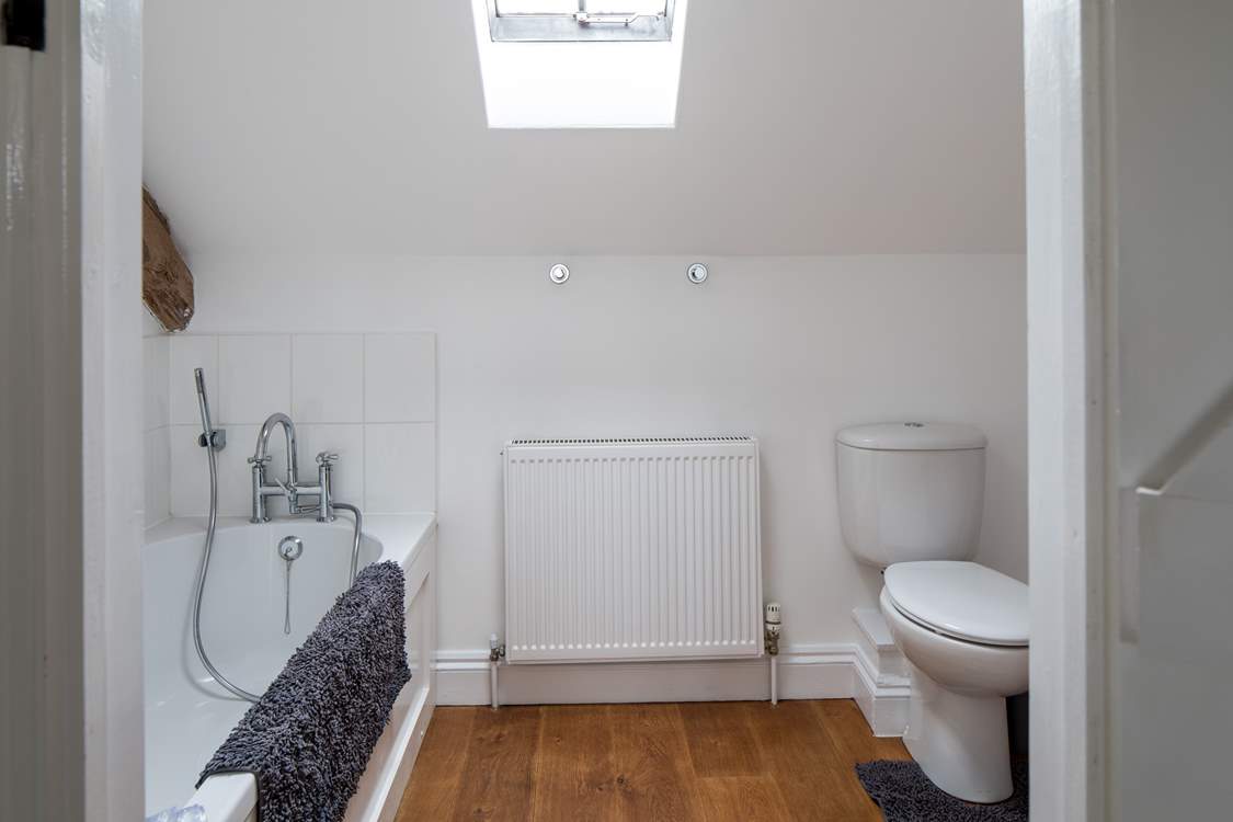 The spacious en suite bathroom has a hand held shower.