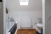 The spacious en suite bathroom has a hand held shower.