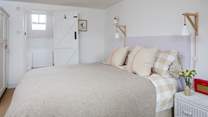 The principal bedroom has a super comfy king-size bed and an en suite bathroom.