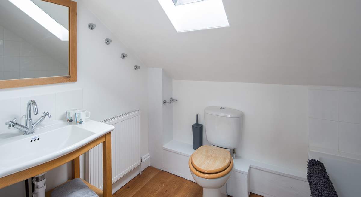 The spacious family bathroom has a shower over the bath.