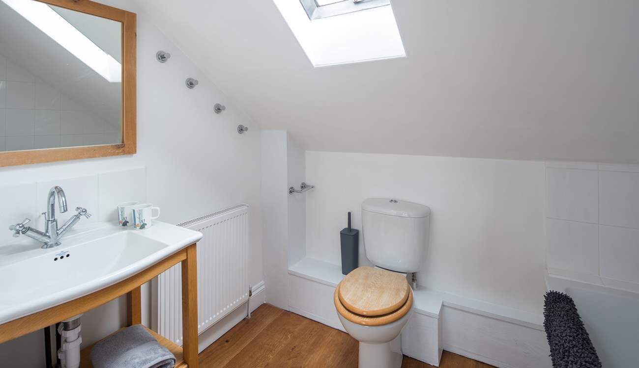 The spacious family bathroom has a shower over the bath.
