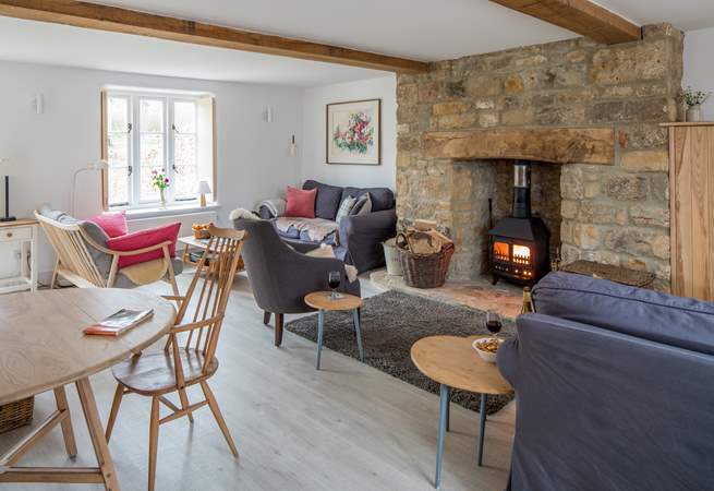 The open plan sitting/dining-room has three sofas to choose from and a cosy wood-burner.