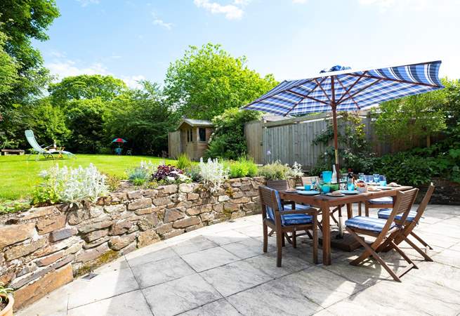 The spacious patio at the rear of the cottage is accessed from both sitting-room and kitchen.