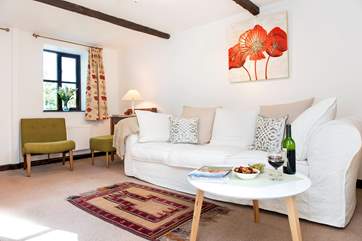 The gorgeous sitting-room leads out to the patio and garden.