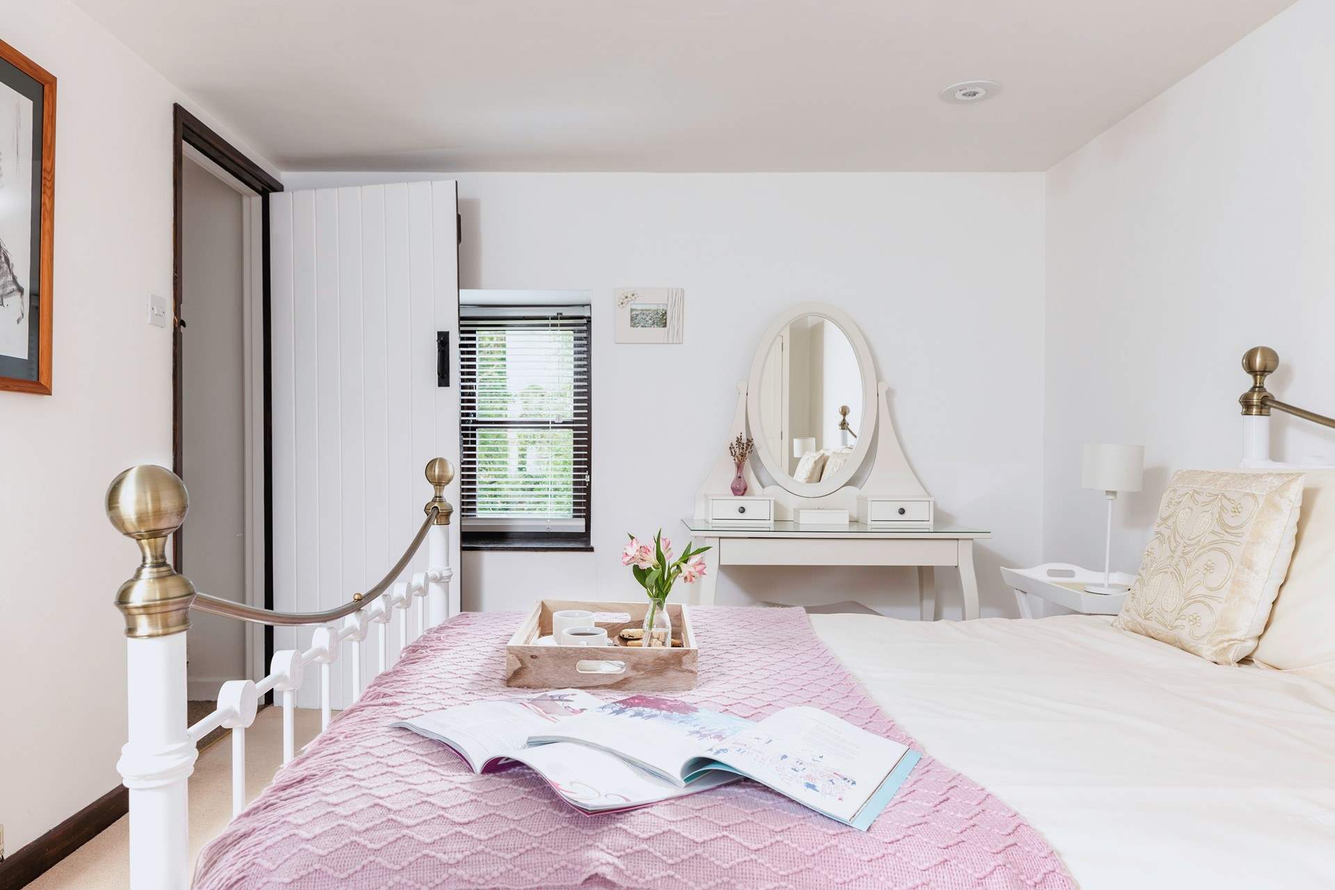 The pretty double bedroom has a feature iron bedstead.