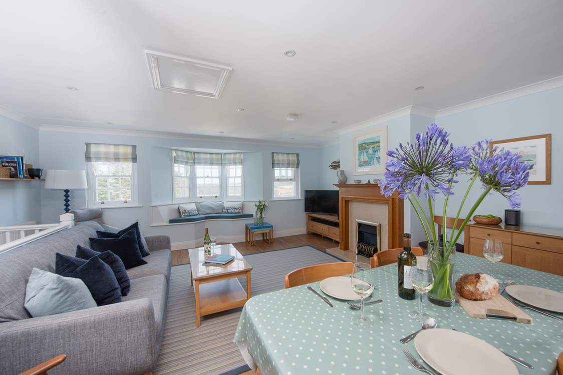 The open plan sitting/dining room is cosy and inviting.