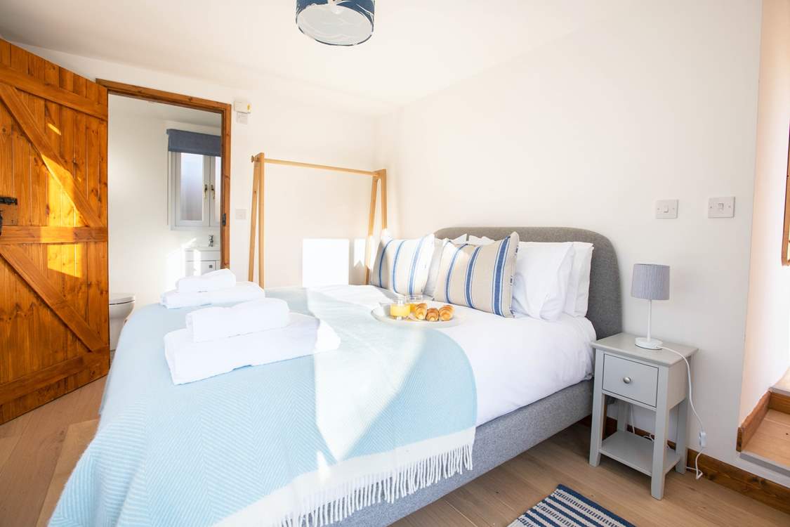 The bedroom is decorated in cool blues and grey.